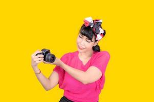 Beautiful and charming women dress in a retro style, Take a film camera to take pictures photo