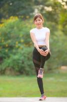 A beautiful Asian woman is warm up, To make the muscles flexible Before going to jogging photo