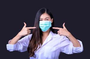 Asian women have to use a mask to cover the face to prevent pollution from dust photo