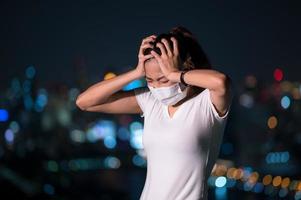 Asian business women have to use a mask to cover the face to prevent pollution from dust photo