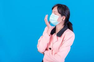 Asian business women have to use a mask to cover the face to prevent pollution from dust photo