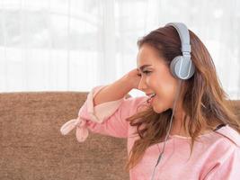 Asian woman are happy to relax by listening to music photo
