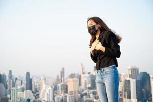 Asian business women have to use a mask to cover the face to prevent pollution from dust photo