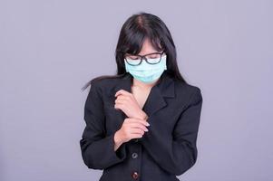 Asian business women have to use a mask to cover the face to prevent pollution from dust photo
