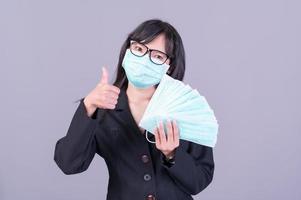 Asian business women have to use a mask to cover the face to prevent pollution from dust photo
