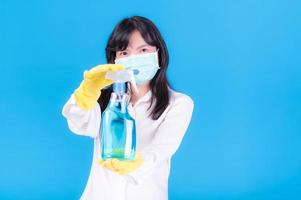 Asian women must use masks to prevent dust pollution and prevent infection from viruses that spread in the air by cleaning using alcohol spray photo