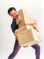 Young man carrying a box  of supplies to send a lot of customers carefully photo