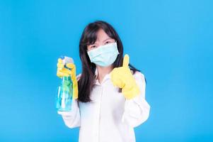 Asian women must use masks to prevent dust pollution and prevent infection from viruses that spread in the air by cleaning using alcohol spray photo