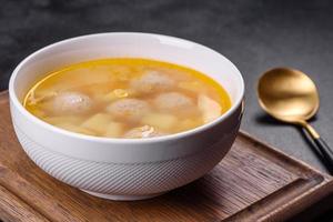 Soup with turkey meatballs, potatoes and vegetables. Selective focus photo