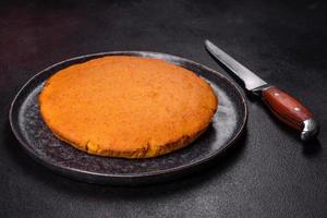 Pumpkin pie, tart made for Thanksgiving day with whipped cream on a black plate photo