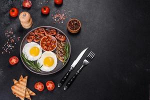 Full english breakfast with bean, fried eggs, roasted sausages, tomatoes and mushrooms photo