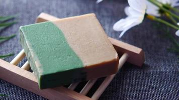 Homemade natural soap bar on black background . video