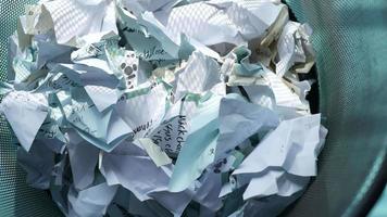 crumpled paper ball in a bin top view . video