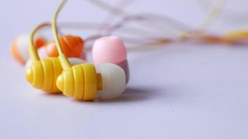 close up of colorful earphone on white background video