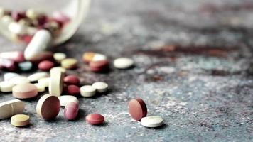 syringe and pills on dark background, close up video