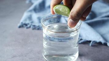 Refreshing lemon water drink on table , top view video