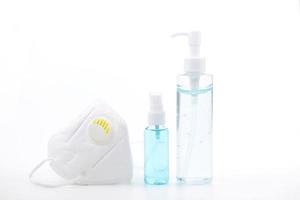 Alcohol gel, spray alcohol and medical face mask on white background which they are a respiratory photo