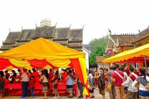 04.14.2022 Xamneua, Houaphanh, Laos. Laos Buddhist to do good things make merit by offer food to the monk. Lao new year or Song Kran. Concept inherit Lao culture. photo