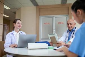 Group of doctors consulting patient records, Elderly doctor and colleague discussing current disease therapy at working place. photo