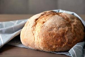 Loaf of freshly baked homemade artisan bread photo