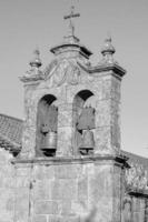 A grayscale shot of a bell tower