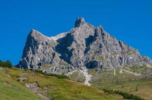 Rural landscape with plants on rocky hills on a sunny day photo