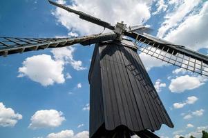 Dutch windmill on a sunny and cloudy day photo