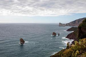 Beautiful view of a sea surrounded by cliffs under a bright sky photo