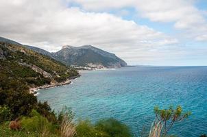 Beautiful view of a sea surrounded by cliffs under a bright sky photo