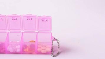 top view of medical pill box on color background video