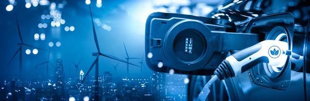 Vehicle EV electric car charge battery with wind turbine and blue sky blur bokeh on panoramic cityscape background. Idea nature electric energy to generate electricity. Green drive energy eco concept photo