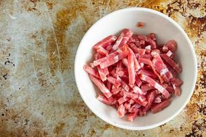 bacon small raw pieces pork meat fumees cuire fresh healthy meal food snack diet on the table copy space food photo