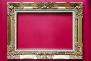 Golden frame. vintage frame isolated from red background photo