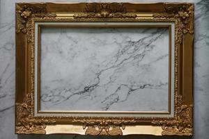 Gold frame Vintage photo frame on marble stone wall background