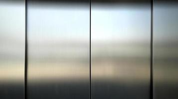 Stainless steel large sheet  With light hitting the surface  For background,Inside passenger elevator,Reflection of light on a shiny metal texture,stainless steel background photo