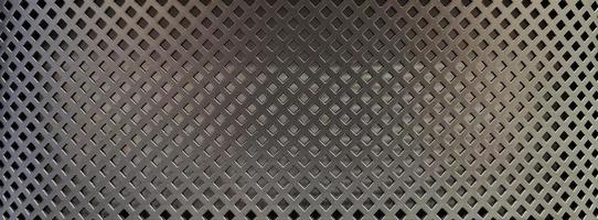 black grid metal background in the dark,protective black seamless mesh background. photo