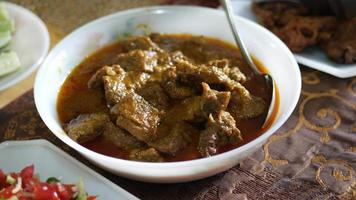 traditional Indian curry lamb masala in a bowl on table. video