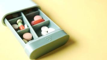 close up of medical pills in a pill box on table video