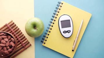 Diabetic measurement tool, apple, and almonds on the table video