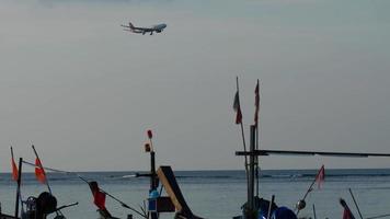 Plane Thai Lion flies over the ocean video