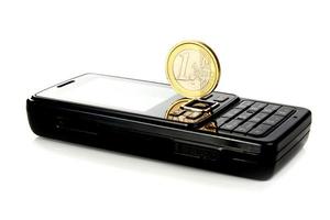 mobile telephone and coin 1 euro photo