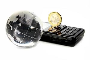 glass globe is a mobile telephone and coin 1 euro photo