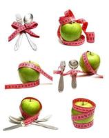 spoon fork and apple is strung by a ribbon for measuring diet photo