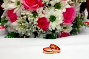 two wedding rings and bouquet photo