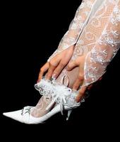 wedding garter in hands on leg photo