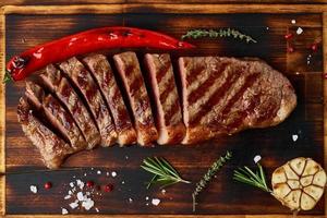 Keto ketogenic diet medium beef steak, grilled striploin on cutting board. Paleo food photo