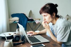 Digital addiction, woman in panic reads articles about coronavirus on Internet, photo
