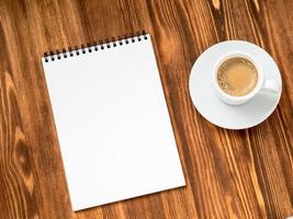 coffee in white cup and open notepad photo