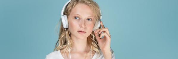 pancarta de largo ancho con retrato de mujer joven escuchando música a través de auriculares foto