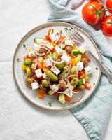 Greek village salad horiatiki with feta cheese and vegetables vertical, copy space photo